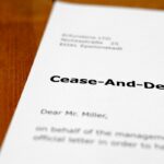 A letter on a wooden desk - cease and desist