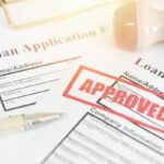 Loan application form with Rubber stamping that says Loan Approved, Financial loan money contract agreement company credit or person - loan approval