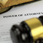 A close-up of a "Power of Attorney" document with a wooden gavel and an open book in the background, conveying a serious legal atmosphere. A close-up of a "Power of Attorney" document with a wooden gavel and an open book in the background, conveying a serious legal atmosphere.